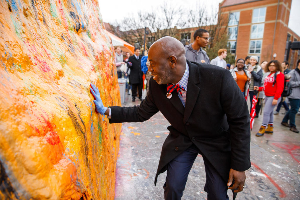 Tyvi Small puts his handprint on the Rock.