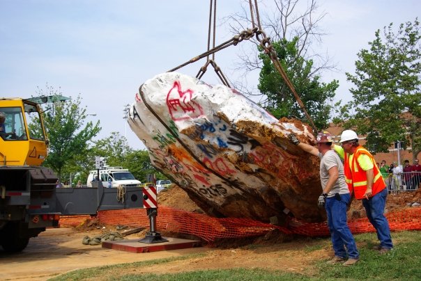 The Rock is hoisted to begin the process of moving its location.